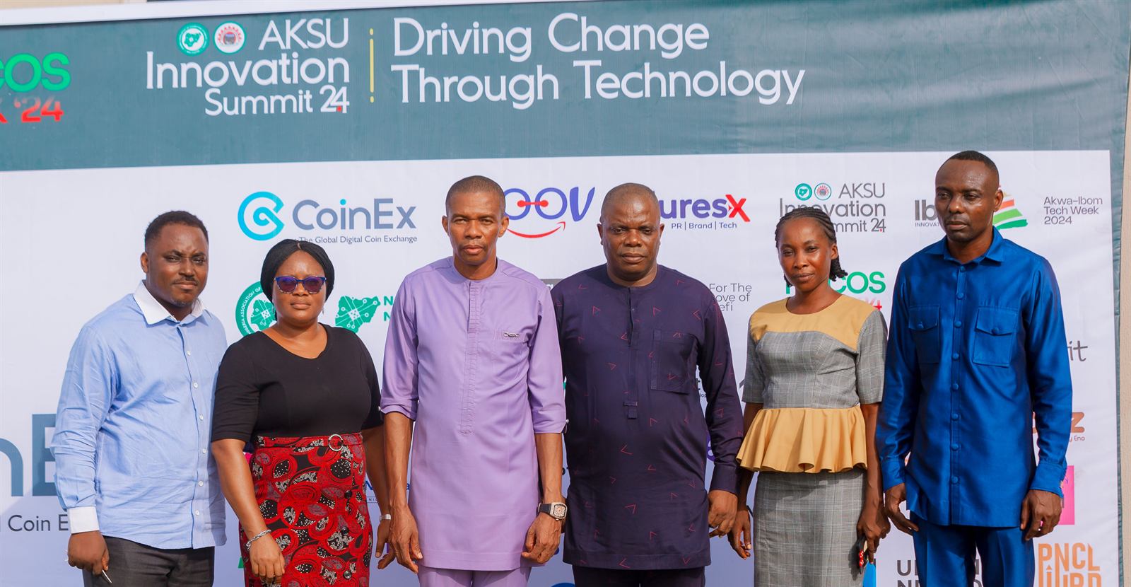 Guests in front of the sponsor backdrop