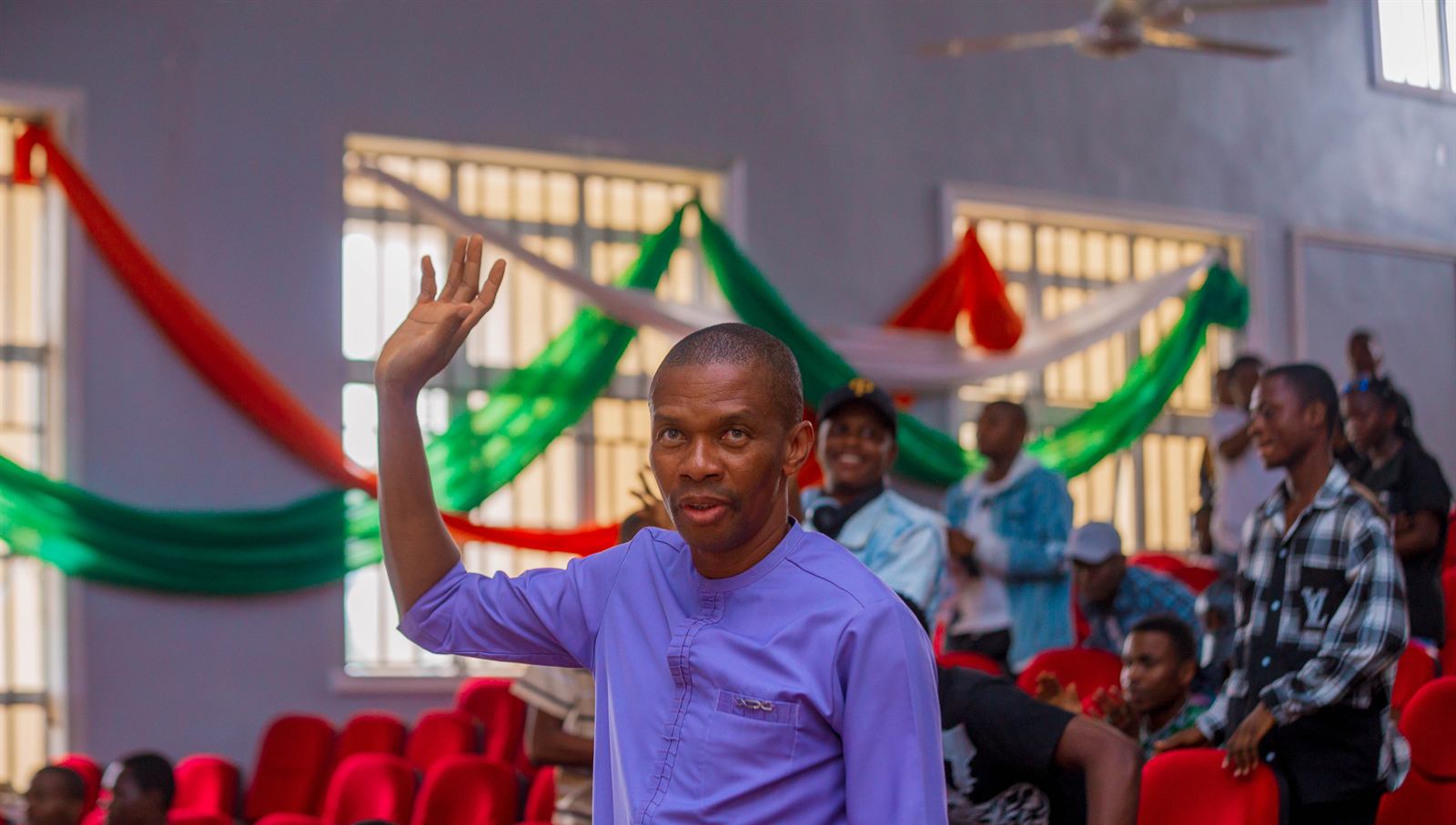 A guest waving from the audience